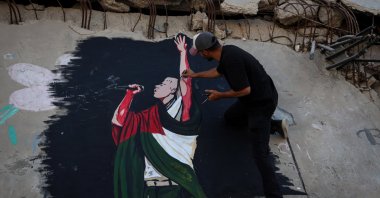 Palestinian artists painted a portrait of American rapper Macklemore on the wall of a destroyed house to thank him for expressing his support for Palestinians in the Gaza Strip, Gaza, Palestine, Sept. 17, 2026. (AA Photo)