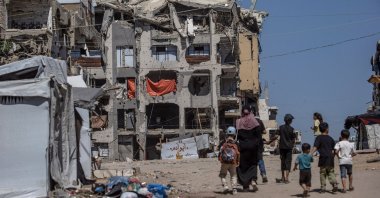 Displaced Palestinians walk near ruined residential buildings in northern Gaza City, Gaza Strip, Sept. 20, 2026. (EPA Photo)