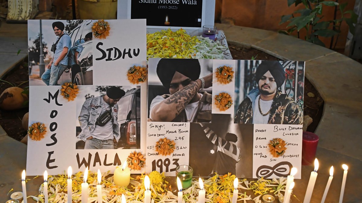 Posters of the late Indian singer Shubhdeep Singh Sidhu, known by his stage name Sidhu Moose Wala are seen at a candlelight vigil, Mumbai, India, June 5, 2022. (Getty Images Photo)