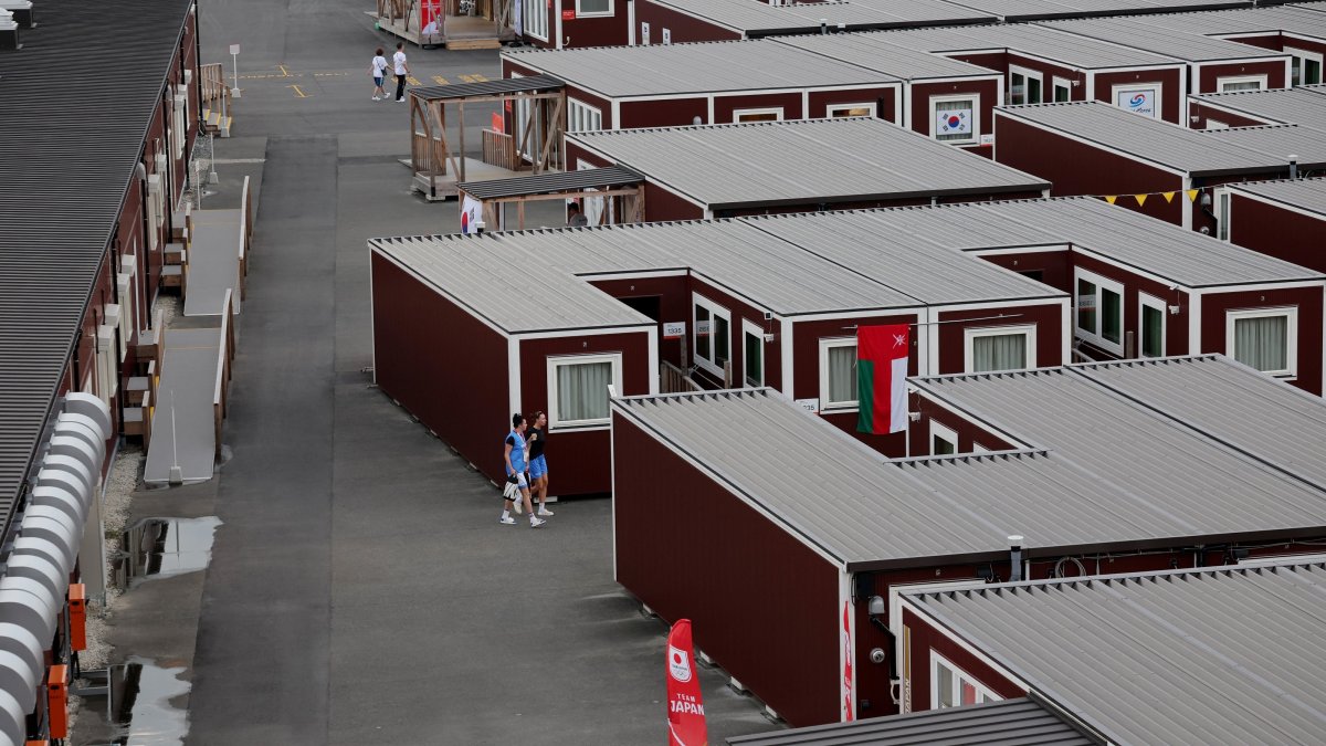 General view of people outside wooden container units in the Athletes' Village ahead of the 2026 Aichi-Nagoya Asian Games, Nagoya, Japan, Sept. 18, 2026. (Reuters Photo)