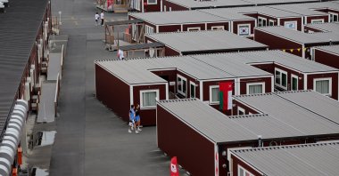 General view of people outside wooden container units in the Athletes' Village ahead of the 2026 Aichi-Nagoya Asian Games, Nagoya, Japan, Sept. 18, 2026. (Reuters Photo)