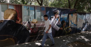 A man walks past an anti-U.S. mural in Tehran, Iran, Sept. 23, 2026. (Reuters Photo)