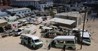 A Palestinian man walks near damaged ambulances and vehicles, amid shortages of fuel and oil needed to run the generators, at Nasser Hospital in Khan Younis, in the southern Gaza Strip, Sept., 2026. (Reuters File Photo)
