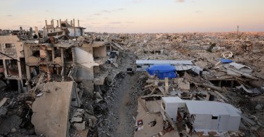 Palestinians stand in front of a tent erected amid the rubble of residential buildings destroyed during the Israeli genocidal military campaign in Gaza City, Sept. 22, 2026. (Reuters Photo)