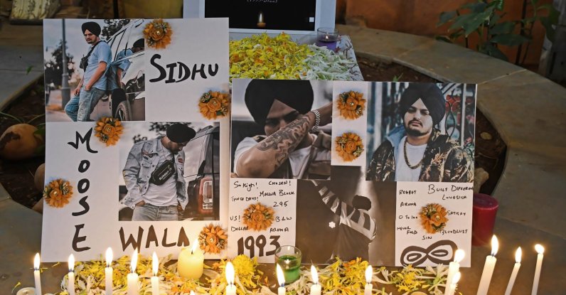 Posters of the late Indian singer Shubhdeep Singh Sidhu, known by his stage name Sidhu Moose Wala are seen at a candlelight vigil, Mumbai, India, June 5, 2022. (Getty Images Photo)
