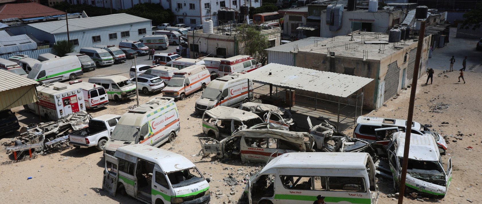 A Palestinian man walks near damaged ambulances and vehicles, amid shortages of fuel and oil needed to run the generators, at Nasser Hospital in Khan Younis, in the southern Gaza Strip, Sept., 2026. (Reuters File Photo)
