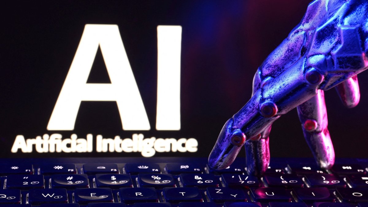 "AI Artificial Intelligence" words, a keyboard and a robotic hand are seen in this illustration taken Sept. 23, 2026. (Reuters Photo)
