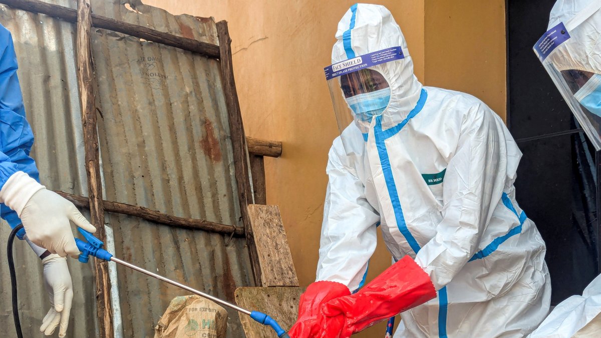 Members of the civil protection team's dignified and safe burial service disinfect after handling the remains of a one-year-old child suspected of having died from Ebola, at the Butembo Unit Hospital morgue, Butembo, DRC, Sept. 13, 2026. (Reuters Photo)