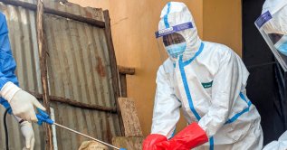 Members of the civil protection team's dignified and safe burial service disinfect after handling the remains of a one-year-old child suspected of having died from Ebola, at the Butembo Unit Hospital morgue, Butembo, DRC, Sept. 13, 2026. (Reuters Photo)