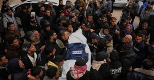 Mourners carry the body of Anas Ghoneim, one of the three Palestinian journalists who were killed in an Israeli strike on an Egyptian committee's vehicle, during his funeral in Khan Younis, Gaza Strip, Palestine, Jan. 22, 2026. (AP Photo)
