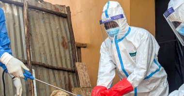 Members of the civil protection team's dignified and safe burial service disinfect after handling the remains of a one-year-old child suspected of having died from Ebola, at the Butembo Unit Hospital morgue, Butembo, DRC, Sept. 13, 2026. (Reuters Photo)