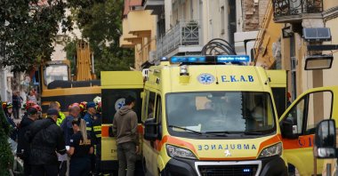 An ambulance waits to transport the body of a person found dead during a search-and-rescue operation after a building partially collapsed following an explosion in the Plaka area, which is popular with tourists, Athens, Greece, Sept. 26, 2026. (Reuters Photo)
