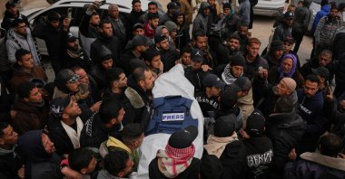 Mourners carry the body of Anas Ghoneim, one of the three Palestinian journalists who were killed in an Israeli strike on an Egyptian committee's vehicle, during his funeral in Khan Younis, Gaza Strip, Palestine, Jan. 22, 2026. (AP Photo)