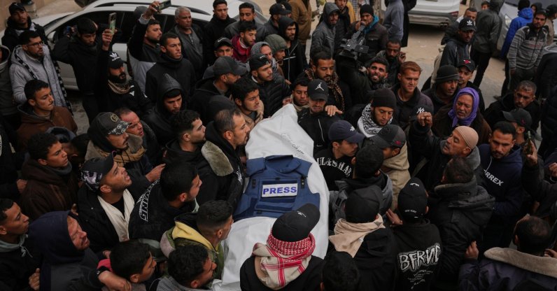 Mourners carry the body of Anas Ghoneim, one of the three Palestinian journalists who were killed in an Israeli strike on an Egyptian committee's vehicle, during his funeral in Khan Younis, Gaza Strip, Palestine, Jan. 22, 2026. (AP Photo)