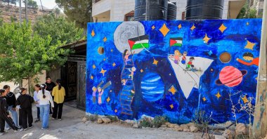 Palestinian children stand outside Rommana studio in Hebron, the Israeli-occupied West Bank, Palestine, Sept. 22, 2026. (Reuters Photo)