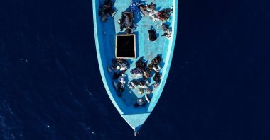 A drone view shows clothes and personal belongings left aboard an empty migrant boat after its occupants were rescued by Italy's Guardia di Finanza between Sicily and Malta in the central Mediterranean, Sept. 16, 2026. (Reuters Photo)