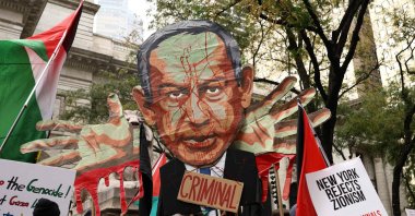 Protesters hold an image of Israeli Prime Minister Benjamin Netanyahu bearing the word "Criminal" and "Free Palestine" signs during a demonstration on the day of his address to the 81st United Nations General Assembly, New York, U.S., Sept. 24, 2026. (AFP Photo)