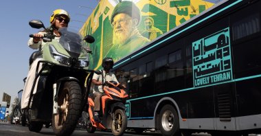 People drive past a billboard depicting former Iranian Supreme Leader Ali Khamenei, in Tehran, Iran, Sept. 27, 2026. (EPA Photo)