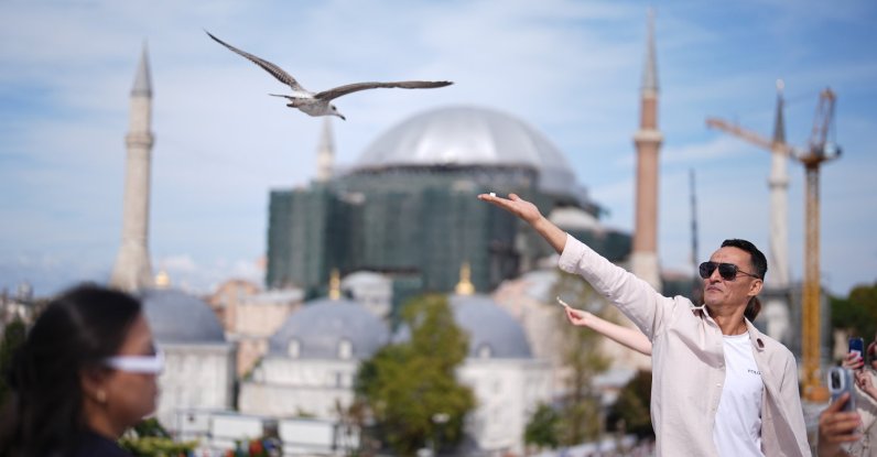 A tourist feeds a seagull on a rooftop close to the popular Sultanahmet Square, Istanbul, Türkiye, Sept. 26, 2026. (AA Photo)