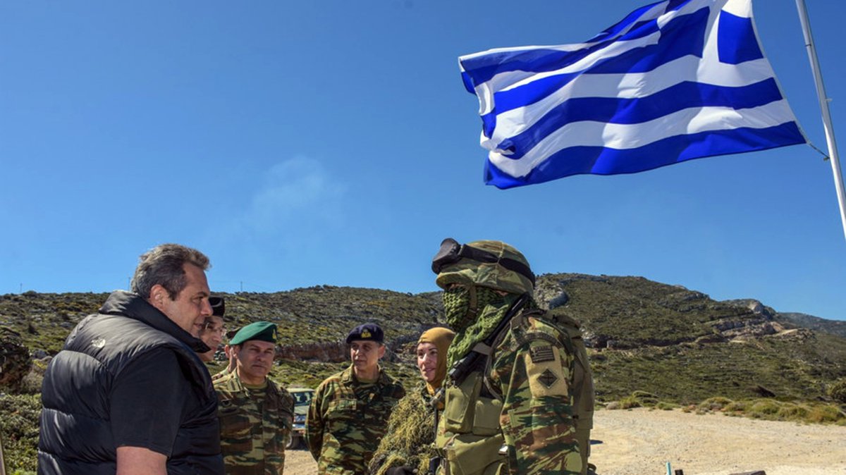 Former Greek Defense Minister Panos Kammenos (L) speaks with soldiers as he attends a reservist exercise, eastern island of Ikaria, Greece, April 4, 2018. (AP Photo)