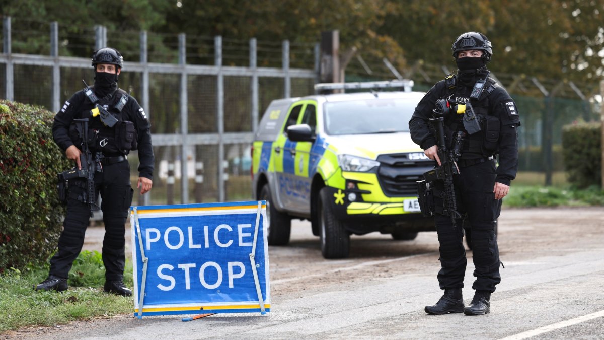 Armed police officers stand guard on a road outside the perimeter of the RAF Fairford airbase, in Fairford, Gloucestershire, U.K., Sept. 28, 2026. (Reuters Photo)