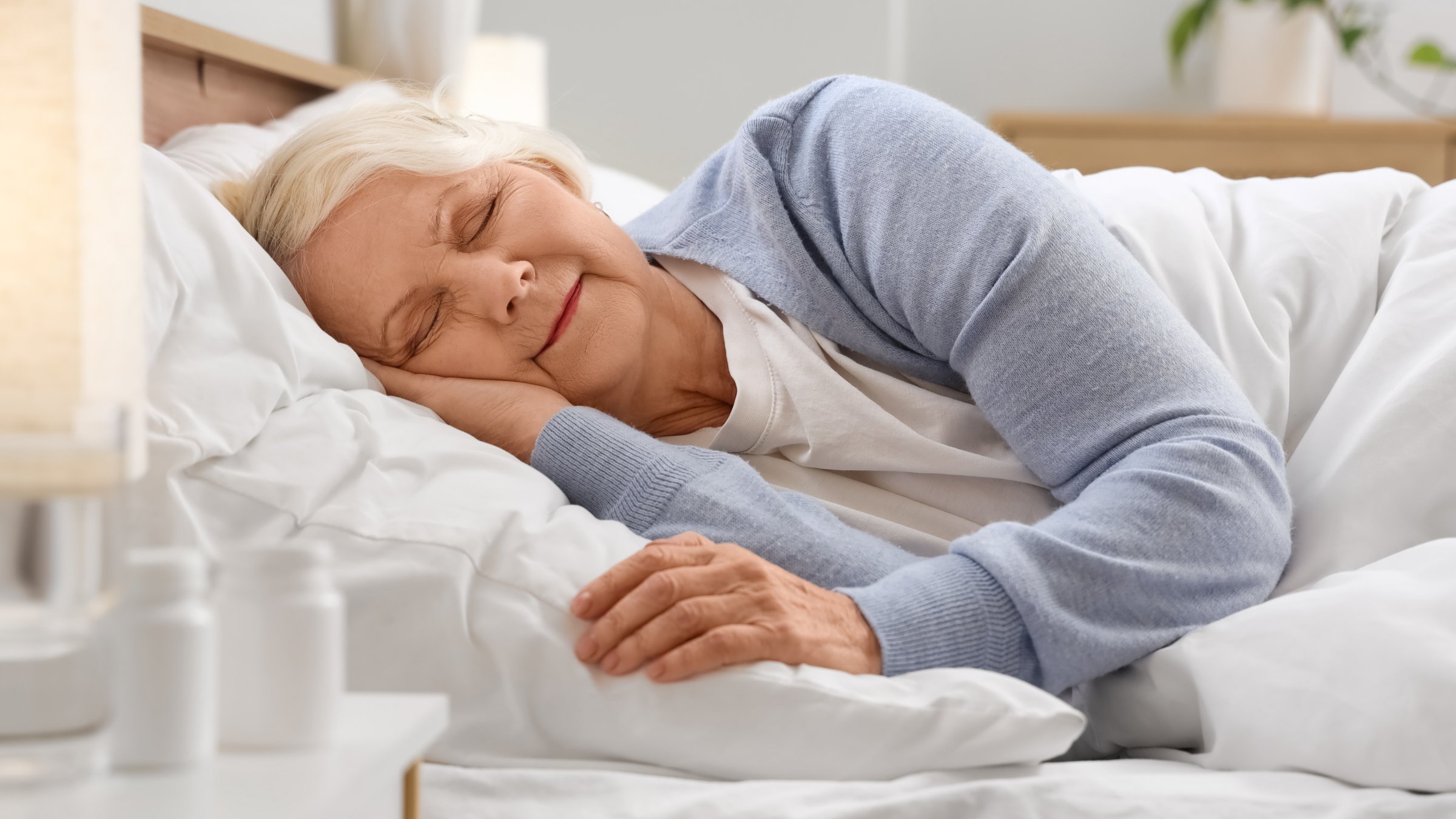 An elderly woman sleeping in her bedroom. (Shutterstock Photo)