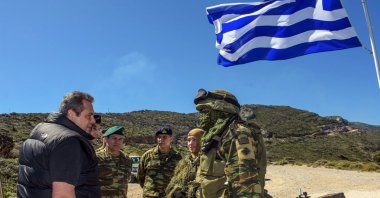 Former Greek Defense Minister Panos Kammenos (L) speaks with soldiers as he attends a reservist exercise, eastern island of Ikaria, Greece, April 4, 2018. (AP Photo)