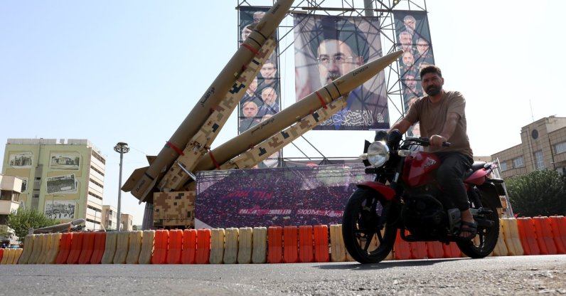 A man drives past Iranian Zolfaghar missiles placed in front of a billboard carrying a picture of Iranian Supreme Leader Ayatollah Mojtaba Khamenei at Baharestan Square in downtown Tehran, Iran, Sept. 28, 2026. (EPA Photo)