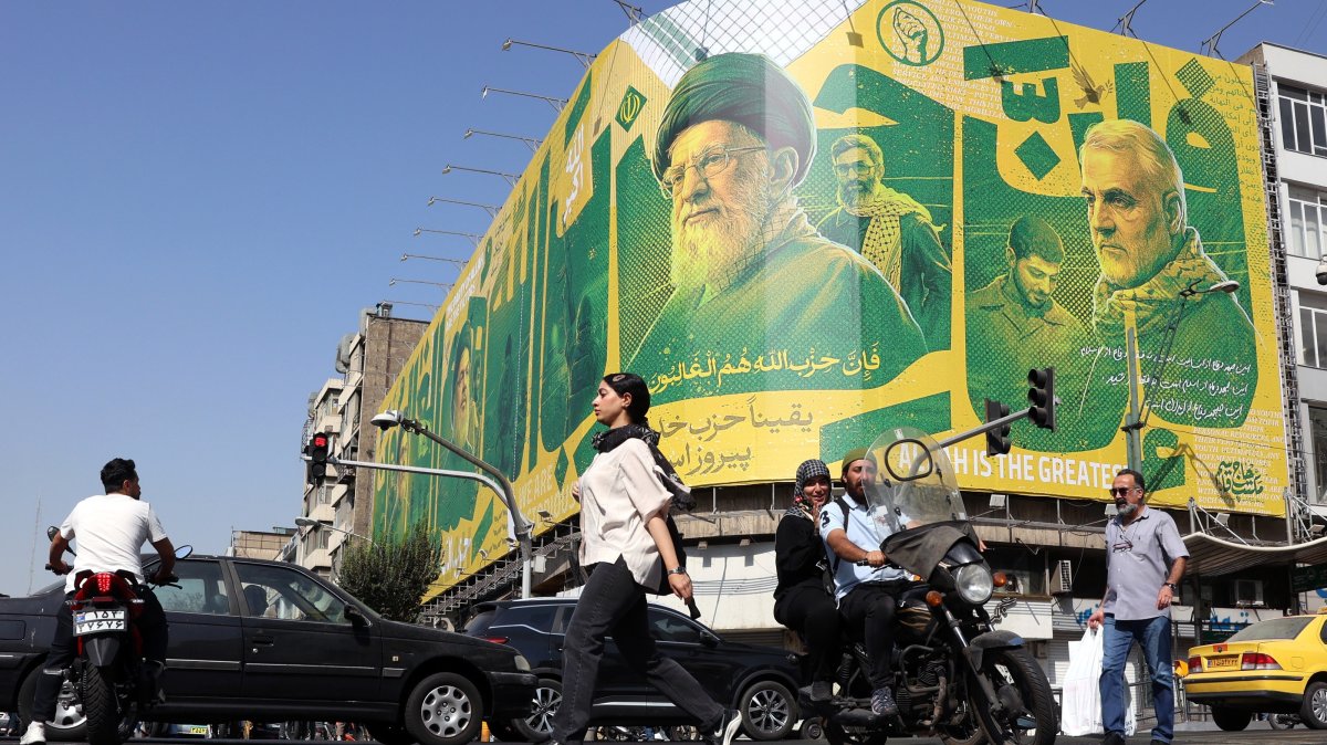 Iranians walk past a billboard depicting former Iranian Supreme Leader Ali Khamenei and former Iranian Quds Force commander Qasem Soleimani, in Tehran, Iran, Sept. 27, 2026. (EPA Photo)