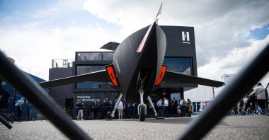 A model of the CA-1 Europa drone, manufactured by the defense contractor Helsing, is on display in front of the company’s booth at the International Aerospace Exhibition (ILA) at the Berlin ExpoCenter Airport, June 11, 2026. (AFP File Photo)