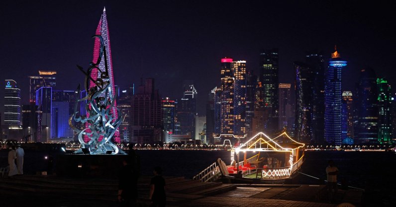 People walk along the Corniche Promenade facing the skyline of illuminated high-rise buildings in Doha, Qatar, Sept. 4, 2026. (AFP Photo)
