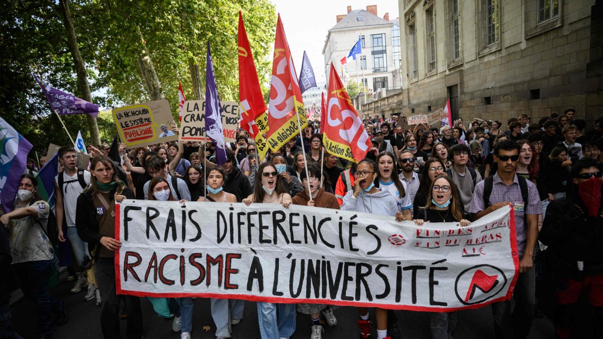 Protesters march with a banner that reads "Differing tuition rates, Racism in university" as they take part in a rally during a day of nationwide public sector strikes and demonstrations, Nantes, western France, Sept. 29, 2026. (AFP Photo)