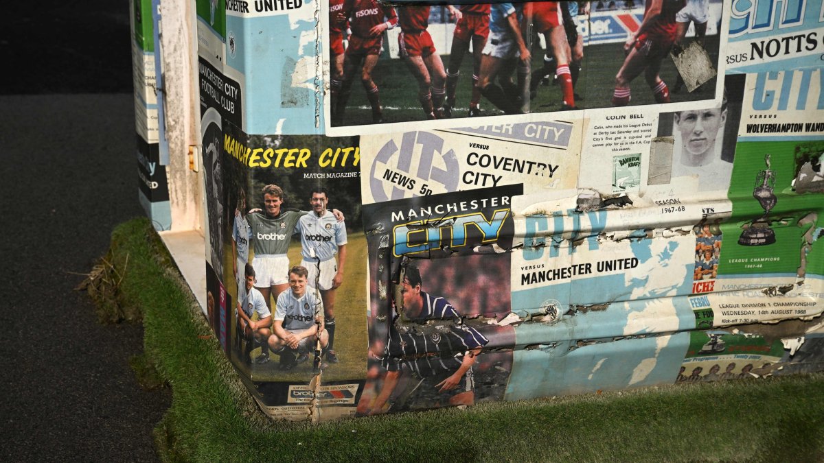 Programmes featuring former players are pictured at a programme seller's booth outside the Etihad Stadium, the home ground of Manchester City Football Club, Manchester, U.K., Sept. 30, 2026. (AFP Photo)