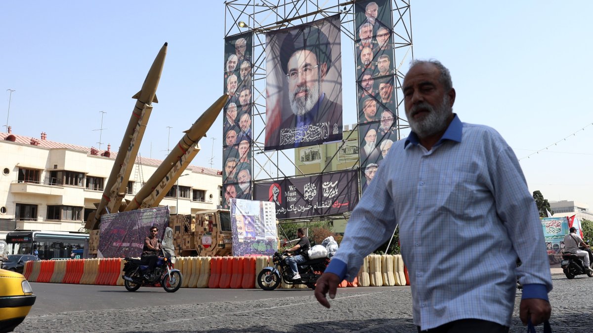 A man walks past Iranian Zolfaghar missiles placed in front of a billboard carrying a picture of Iranian Supreme Leader Ayatollah Mojtaba Khamenei, Tehran, Iran, Sept. 28, 2026. (EPA Photo)