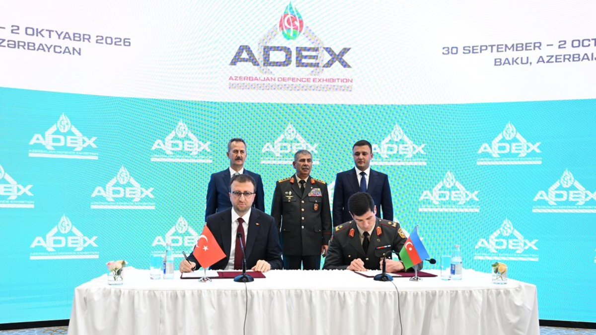 The head of SSB Haluk Görgün (L) and Azerbaijan's Defense Minister Zakir Hasanov (C) oversee the signing of agreements during ADEX 2026, Baku, Azerbaijan, Sept. 30, 2026. (AA Photo)