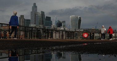 Skyscrapers of the City of London financial district are reflected in a puddle following heavy rain, in London, Britain, Sept. 8, 2026. (Reuters Photo)