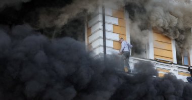 Ihor Malchevsky, 69, a deputy department head at Ukraine's National Academy of Sciences, evacuates the site of an administrative building hit by a Russian jet-powered drone strike, amid Russia's attack on Ukraine, in Kyiv, Ukraine, Sept. 30, 2026. (Reuters Photo)