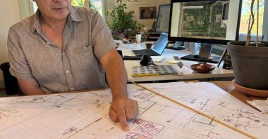 Archaeologist Pierre Blanc, head of excavations for the Roman site and museum of Avenches, points to new Roman buildings added to the map, Vaud, Switzerland, Sept. 28, 2026. (Reuters Photo)