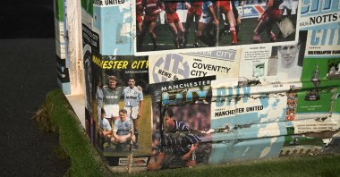 Programmes featuring former players are pictured at a programme seller's booth outside the Etihad Stadium, the home ground of Manchester City Football Club, Manchester, U.K., Sept. 30, 2026. (AFP Photo)