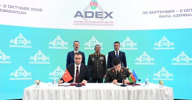 The head of SSB Haluk Görgün (L) and Azerbaijan's Defense Minister Zakir Hasanov (C) oversee the signing of agreements during ADEX 2026, Baku, Azerbaijan, Sept. 30, 2026. (AA Photo)