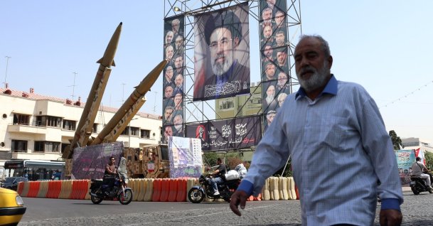 A man walks past Iranian Zolfaghar missiles placed in front of a billboard carrying a picture of Iranian Supreme Leader Ayatollah Mojtaba Khamenei, Tehran, Iran, Sept. 28, 2026. (EPA Photo)