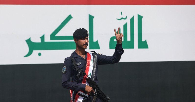 A member of the Iraqi security forces flashes the V-sign for victory during a military parade marking the withdrawal of the U.S.-led coalition, Baghdad, Iraq, Sept. 30, 2026. (AFP Photo)