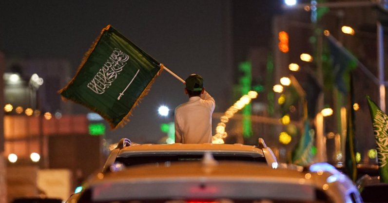 A child waves a Saudi flag from a car window during celebrations on Saudi Arabia's 96th National Day, in Riyadh, Saudi Arabia, Sept. 23, 2026.