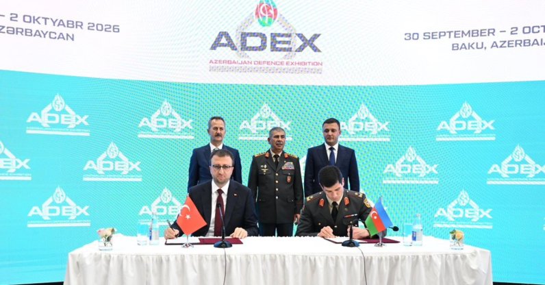 The head of SSB Haluk Görgün (L) and Azerbaijan's Defense Minister Zakir Hasanov (C) oversee the signing of agreements during ADEX 2026, Baku, Azerbaijan, Sept. 30, 2026. (AA Photo)