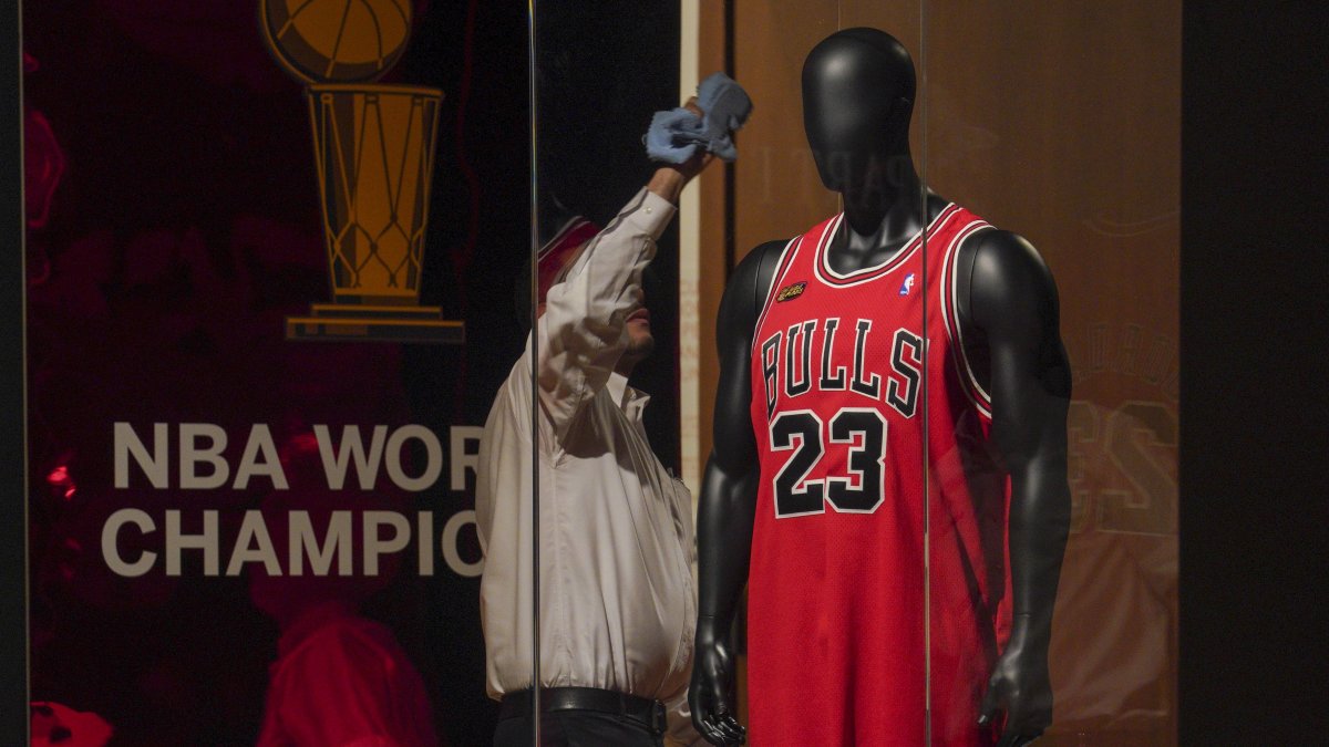 Michael Jordan's 1998 finals game jersey from his "Last Dance" season is displayed in a glass case, highlighting Sotheby's sports memorabilia auction dubbed "Invictus," New York City, U.S., Sept. 6, 2022. (AP Photo)
