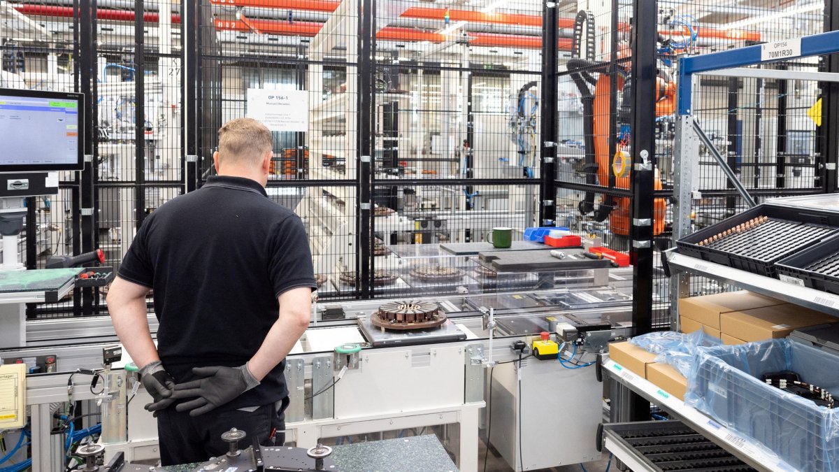 A worker assembles axial-flux motors for electric vehicles on an assembly line at the Mercedes-Benz engine factory, Berlin, Germany, June 9, 2026. (Reuters Photo)