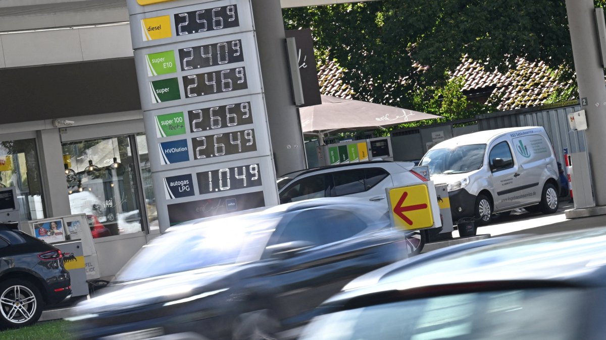 Cars drive past a display board showing the current prices of petrol and diesel at a gas station in Munich, Germany, Sept. 14, 2026. (Reuters Photo)