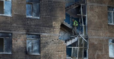 A police bomb squad member works at a site of a damaged school hit by a Russian jet-drone strike, in Kyiv, Ukraine, Oct. 1, 2026. (Reuters Photo)
