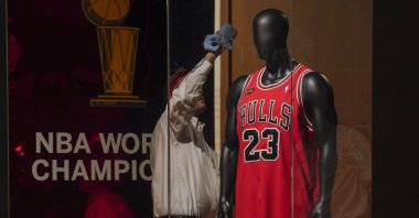 Michael Jordan's 1998 finals game jersey from his "Last Dance" season is displayed in a glass case, highlighting Sotheby's sports memorabilia auction dubbed "Invictus," New York City, U.S., Sept. 6, 2022. (AP Photo)