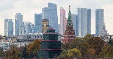 A pedestrian uses a mobile phone while standing on a bridge near the Kremlin wall, in Moscow, Russia, Oct. 23, 2025. (Reuters Photo)